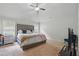 Comfortable primary bedroom with neutral walls, carpet flooring, windows with natural light and furnishings at 11028 Southwood Dr, Hampton, GA 30228