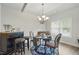 Bright dining room with elegant chandelier, stylish furniture, and natural light from a window at 11028 Southwood Dr, Hampton, GA 30228