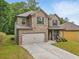 Lovely two-story home with brick and siding, a manicured lawn, and a welcoming front porch at 11028 Southwood Dr, Hampton, GA 30228