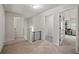 Upstairs hallway featuring neutral carpet and a view into the laundry room at 11028 Southwood Dr, Hampton, GA 30228