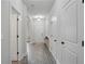 Bright hallway featuring hardwood floors and multiple doors offering access to different rooms at 11028 Southwood Dr, Hampton, GA 30228