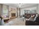 Inviting living room with brick fireplace, plush seating, natural light, and seamless flow into the kitchen at 11028 Southwood Dr, Hampton, GA 30228