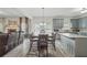 Open-concept kitchen and living area with fireplace, granite countertops, and stainless appliances at 11028 Southwood Dr, Hampton, GA 30228