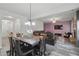 Inviting living and dining area with modern light fixture and open layout to the living area with stylish accent wall at 11028 Southwood Dr, Hampton, GA 30228