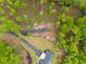 Aerial view of a lush lot with a paved driveway leading to a home with a gray roof at 281 Abbott Dr, Canton, GA 30114