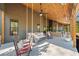 Inviting back porch featuring comfortable porch swing, rockers, and outdoor seating at 281 Abbott Dr, Canton, GA 30114