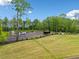 Spacious backyard with well-maintained lawn, gravel area, and ample tree coverage at 281 Abbott Dr, Canton, GA 30114