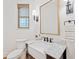 Charming bathroom with marble counters, farmhouse sink, and bronze fixtures with plenty of natural light at 281 Abbott Dr, Canton, GA 30114