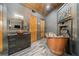 This luxury bathroom features a copper soaking tub, wood ceiling, and dark wood cabinets at 281 Abbott Dr, Canton, GA 30114