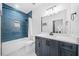 Modern bathroom with blue tile shower, white countertops and sleek fixtures at 281 Abbott Dr, Canton, GA 30114