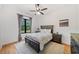 Cozy bedroom with a window, ceiling fan, wood flooring, and natural light at 281 Abbott Dr, Canton, GA 30114