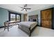 Bedroom featuring blue walls, carpet, natural light, a ceiling fan, and wood trim at 281 Abbott Dr, Canton, GA 30114
