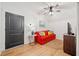 Cozy bonus room with red sofa, TV, and a ceiling fan for relaxed living at 281 Abbott Dr, Canton, GA 30114