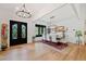 Stylish dining room with elegant chandelier, hardwood floors, and black framed glass doors at 281 Abbott Dr, Canton, GA 30114