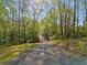 Long gravel driveway through a dense forest at 281 Abbott Dr, Canton, GA 30114