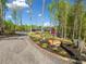 A gravel driveway leads to a hidden home among mature trees on the property at 281 Abbott Dr, Canton, GA 30114