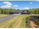 Stunning exterior of home with manicured lawn, long driveway and attached two-car garage at 281 Abbott Dr, Canton, GA 30114