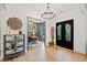 Elegant foyer with hardwood flooring, modern lighting, and decorative wall art at 281 Abbott Dr, Canton, GA 30114