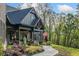 Charming exterior showcasing stone accents, covered porch, landscaping, and a winding walkway at 281 Abbott Dr, Canton, GA 30114