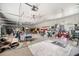 Large, cluttered garage with high ceilings, ceiling fans, and ample storage space at 281 Abbott Dr, Canton, GA 30114