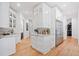Bright kitchenette with white cabinets, granite countertops, and stainless steel refrigerator at 281 Abbott Dr, Canton, GA 30114