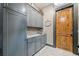 This laundry room has gray cabinets, a sink, and a wood-paneled door at 281 Abbott Dr, Canton, GA 30114
