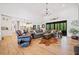 Open-concept living room with high ceilings, hardwood floors, a comfortable sofa, and a view of the backyard at 281 Abbott Dr, Canton, GA 30114