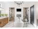 Elegant bathroom featuring a soaking tub, dual walk-in showers, dual vanities, and a television at 281 Abbott Dr, Canton, GA 30114