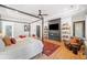 Primary bedroom boasts a sitting area, fireplace, mounted television and natural light at 281 Abbott Dr, Canton, GA 30114