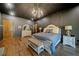 This spacious bedroom features hardwood floors, a chandelier, a sitting bench, and modern furnishings at 281 Abbott Dr, Canton, GA 30114