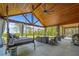 Inviting outdoor living area with a swing bed, seating, and a view of the surrounding landscape at 281 Abbott Dr, Canton, GA 30114