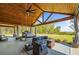 Spacious outdoor living area featuring comfortable seating, a swing bed, and a view of the backyard at 281 Abbott Dr, Canton, GA 30114