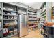 Walk-in pantry with custom shelving and stainless steel refrigerator provides ample storage at 281 Abbott Dr, Canton, GA 30114