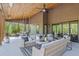 Relax on this spacious covered patio with outdoor furniture and beautiful wooded views at 281 Abbott Dr, Canton, GA 30114