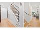 Modern staircase with wood treads, black metal railing, and bright natural light at 281 Abbott Dr, Canton, GA 30114