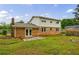 Back exterior view of the brick home, featuring a patio, lawn, with a fenced yard for privacy and outdoor living at 3909 Ebenezer Rd, Marietta, GA 30066