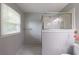 Neutral bathroom with large window and tiled floors at 3909 Ebenezer Rd, Marietta, GA 30066