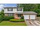 Charming two-story home with brick and vinyl siding and a well-manicured front yard at 3909 Ebenezer Rd, Marietta, GA 30066