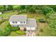 Two-story home with a two-car garage, showcasing mature trees and lush landscaping at 3909 Ebenezer Rd, Marietta, GA 30066