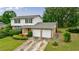 Beautiful brick and white home with a two-car garage and well-maintained landscaping at 3909 Ebenezer Rd, Marietta, GA 30066