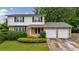 Charming two-story home with brick and vinyl siding, an attached two-car garage, and a well-maintained front yard at 3909 Ebenezer Rd, Marietta, GA 30066
