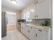 Kitchen featuring white cabinets, tile floors, stainless steel appliances, and decorative backsplash at 3909 Ebenezer Rd, Marietta, GA 30066