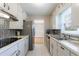Galley kitchen with white cabinetry, tile backsplash, and stainless steel appliances at 3909 Ebenezer Rd, Marietta, GA 30066