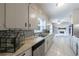 Galley kitchen showcasing white cabinets, stainless steel appliances, and stylish backsplash at 3909 Ebenezer Rd, Marietta, GA 30066