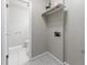 Laundry area with tile floors, washer/dryer hookups, and storage shelf at 3909 Ebenezer Rd, Marietta, GA 30066