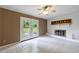 Bright living area featuring a decorative fireplace, tiled floor, and patio access through double doors at 3909 Ebenezer Rd, Marietta, GA 30066