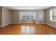 Bright living room featuring hardwood floors and large windows for natural light at 3909 Ebenezer Rd, Marietta, GA 30066