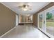 Open living area with tiled floor, connecting to kitchen, and access to backyard through double doors at 3909 Ebenezer Rd, Marietta, GA 30066