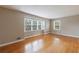 Sunny living room with hardwood floors, neutral walls, and large windows, offering a warm and inviting atmosphere at 3909 Ebenezer Rd, Marietta, GA 30066