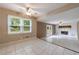 Open-concept living area with tiled floors, ceiling fans, and large windows overlooking yard at 3909 Ebenezer Rd, Marietta, GA 30066